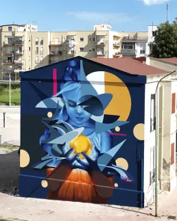 Graffiti mural of a girl with yellow light by Zurik